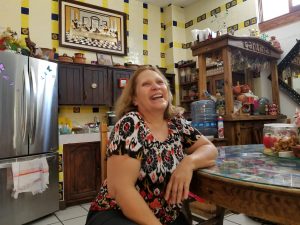 a woman sits in a kitchen